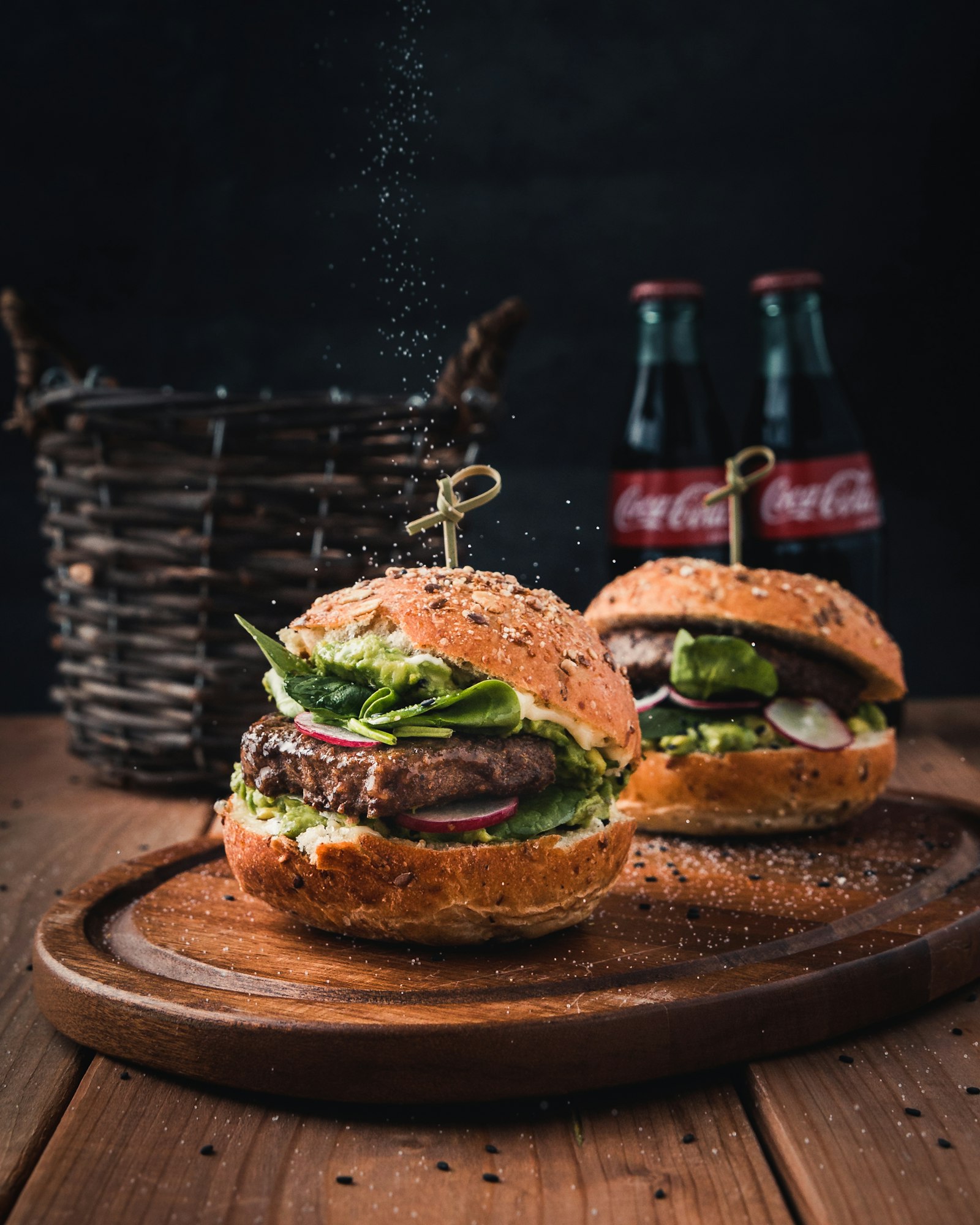 Two burgers with drinks